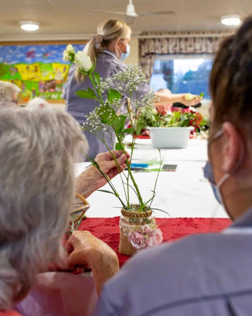 Residents arranging flowers at Upper Mead Care Home