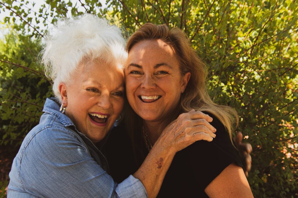 resident and family hugging in the garden