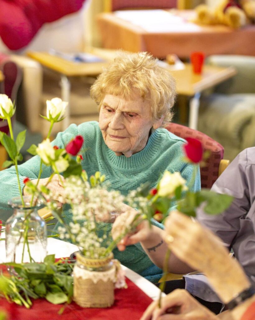 resident doing flower picking at Upper Mead Care Home