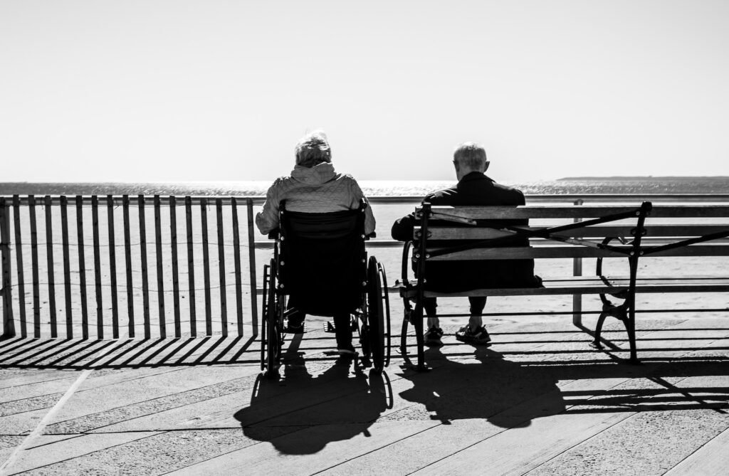 residents in wheelchair and on bench