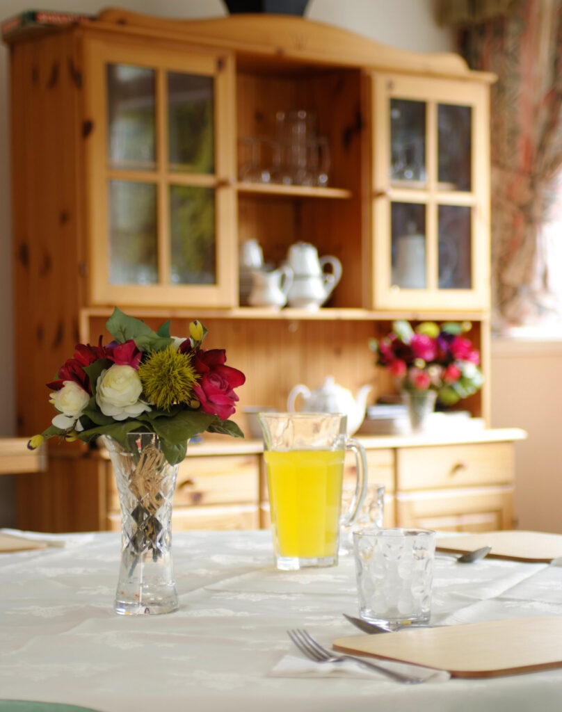 juice and flowers on table at upper mead care home