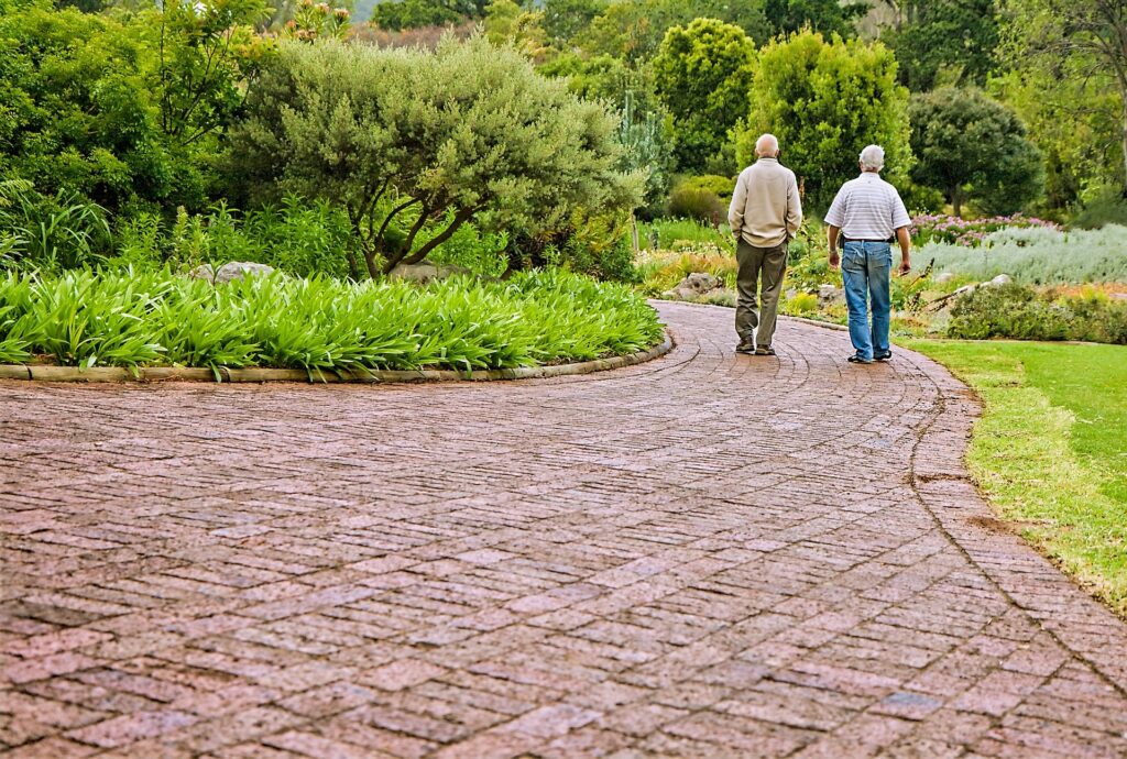 two men walking on a brick path