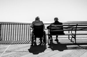 a man and woman sitting on benches