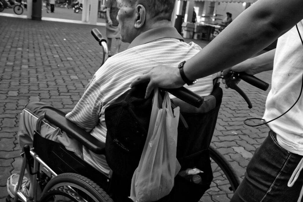 a person in a wheelchair holding a bag