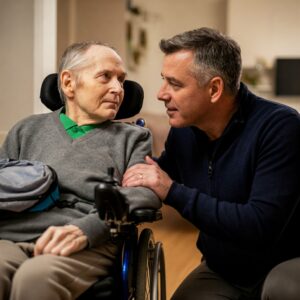 A resident and carer laughing in a foyer space